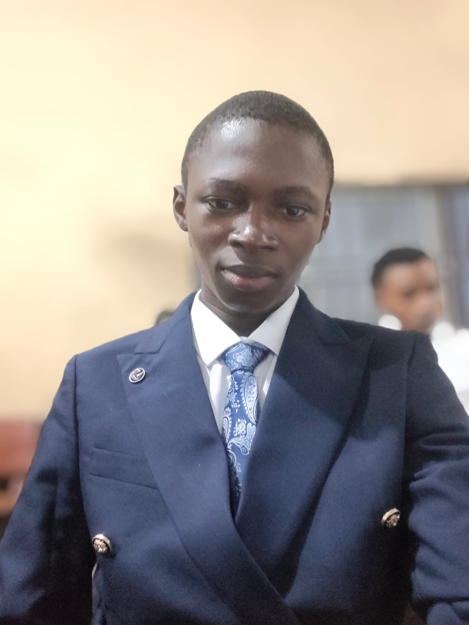 Peters Elijah wearing a navy suit and tie